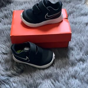 Nike black w/ white velcro sneakers in box. Size 4c